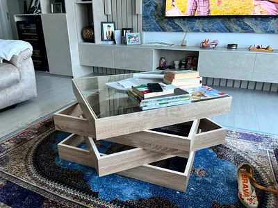 Modern layered wooden coffee table with glass top — good condition