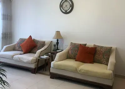 Pair of cream 2-seater sofas with patterned cushions (good condition)
