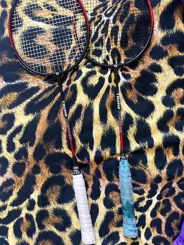 Pair of used Triumph badminton rackets with grips