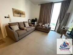 A stunning one-bedroom apartment with a living room and balcony in the Aljada area of Sharjah.