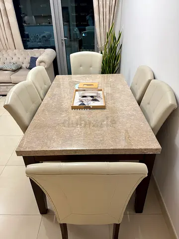 Marble-top dining table with 6cream leather chairs