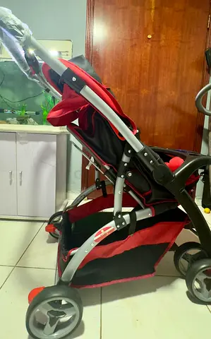 Lightweight red baby stroller - folds, good condition