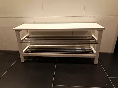 White wooden bench with metal shoe racks - good condition