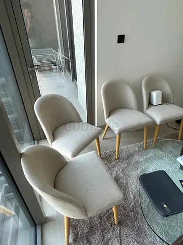 Set of 4 modern beige dining chairs with wooden legs — good condition