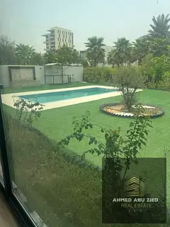 Villa for sale in Al Zorah The property features a ground floor, a first floor, a perimeter wall, a