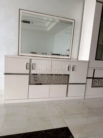 Glossy cream sideboard cabinet with decorative metal inlay and mirror