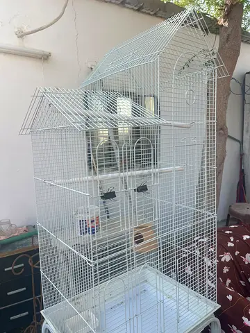 Large white metal bird cage on wheels — good condition