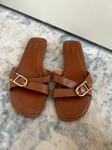 Brown leather-look slip-on sandals with gold buckle, EU38