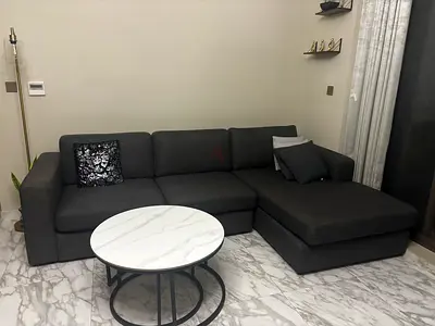 Dark grey L-shaped fabric corner sofa with chaise