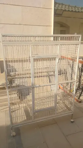 Large white metal bird/parrot cage on wheels.