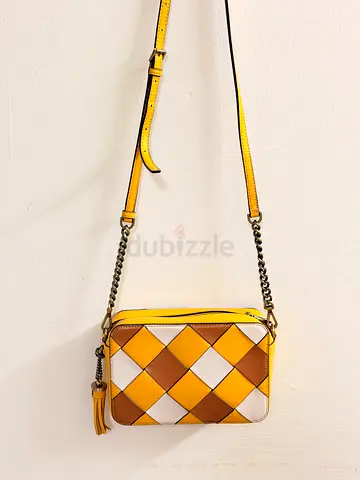 Yellow woven leather crossbody bag with chain strap