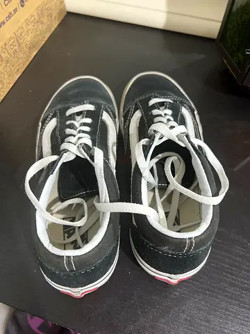 Used black and white Vans-style sneakers, size unknown