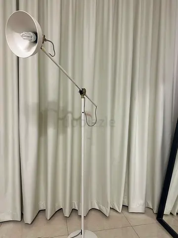 Adjustable floor swing-arm lamp with white metal shade