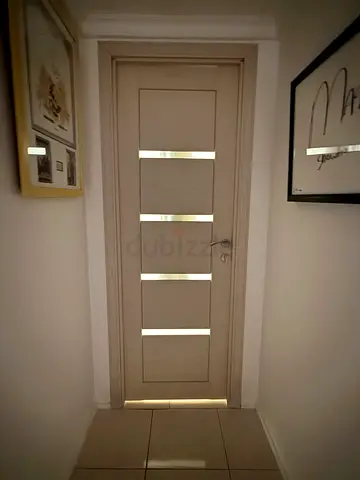 Solid wooden interior door with modern panel design - beige/cream