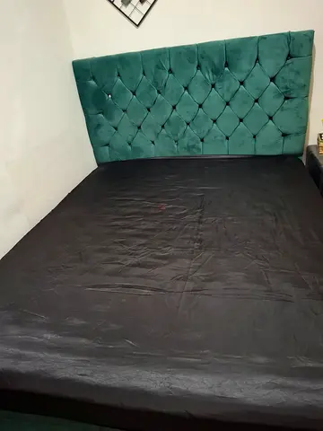 Green tufted upholstered queen bed with headboard