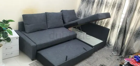 Grey L-shaped sofa with under-seat storage — good condition
