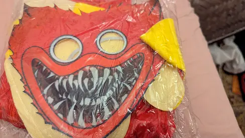 Red monster plush toy (new, sealed) — small stuffed character