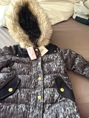 Warm girls winter parka with faux fur hood, size tag visible, brand new
