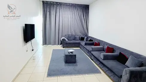 Furnished two-bedroom apartment with a living room, excellent space, balcony with an open view, available for monthly rent in Ajman.