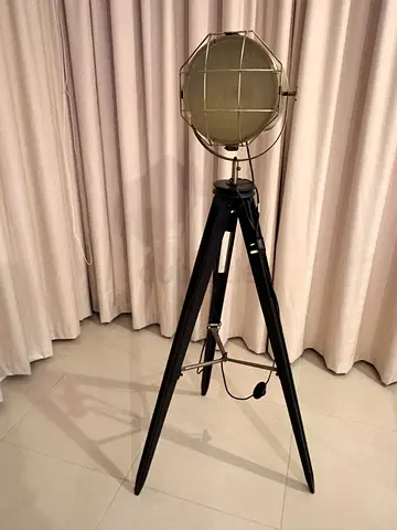 Industrial tripod floor lamp with spotlight head — black metal