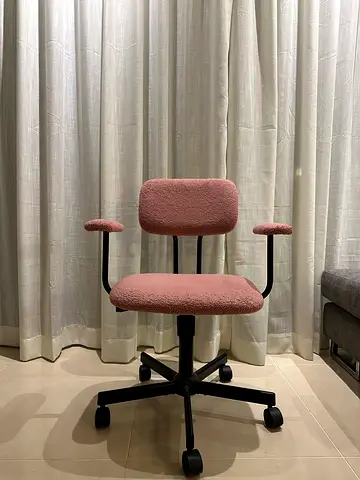 Pink ergonomic office chair with lumbar support and casters