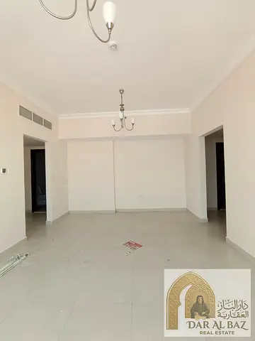 Two-bedroom apartment with a living room available for annual rent in Al Butina, Sharjah. Located in a modern tower (second occupancy), it features ce