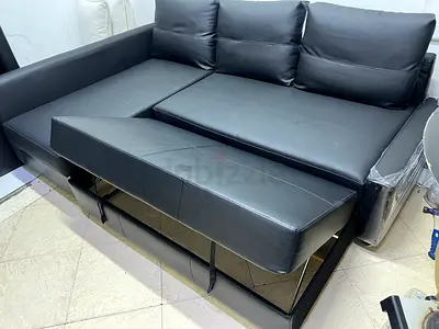 Black leather sofa bed with storage - good condition
