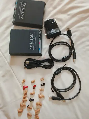 Assorted hearing aid shells, chargers and cables - used parts bundle