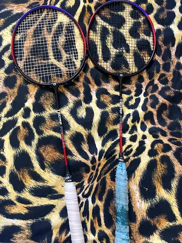 Pair of used Triumph badminton rackets with grips