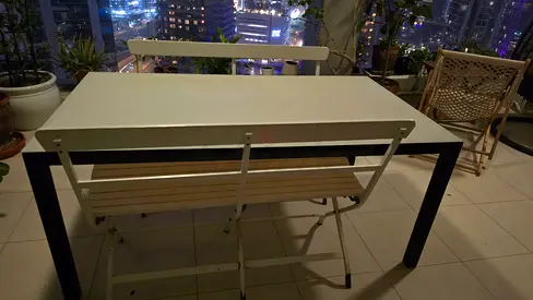 Outdoor table with glass surface and 2 matching white benches for sale