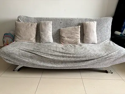 3-seater grey fabric sofa bed with cushions