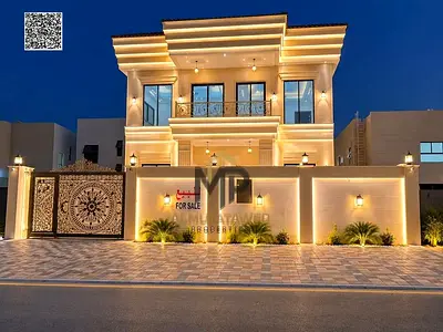 Distinctive villa for sale in Al Zahia, Ajman, featuring 4 bedrooms, a majlis, two living areas, and a maid's room. It includes central air conditioni