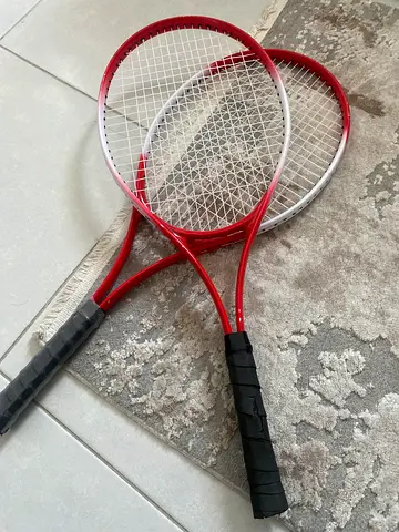 Pair of used red tennis rackets - good condition