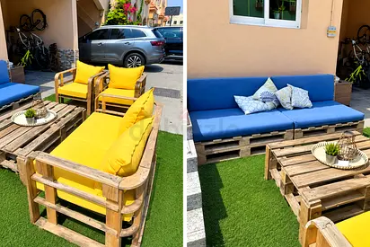 Outdoor pallet sofa set with cushions — blue 3-seater and two yellow armchairs