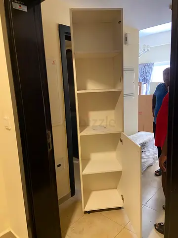 Tall white storage cabinet with shelves - good condition