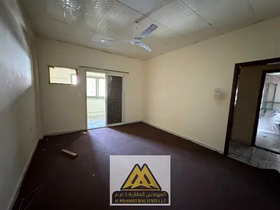 Ajman Industrial, opposite Al Ittihad Bridge. 2BR, 2 baths, no AC, shared accommodation. AED 25,008/year.