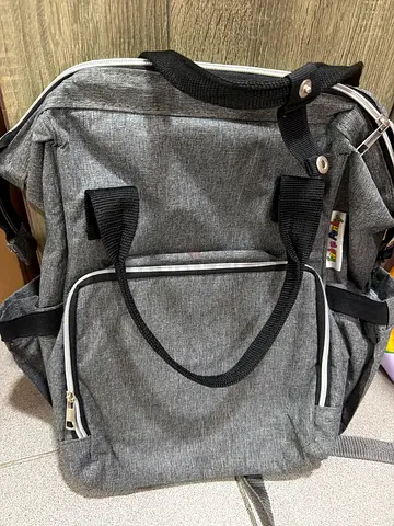 Grey diaper bag with front pockets — good condition
