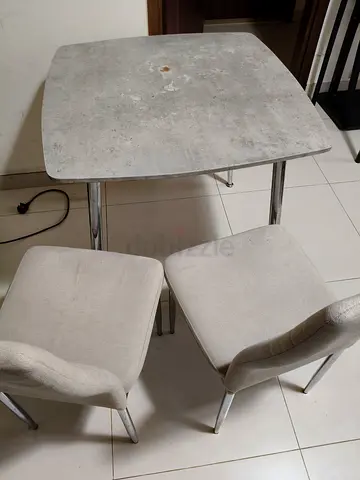 Compact dining table with two upholstered chairs - used