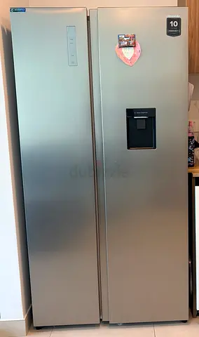 like new, refrigerator side by side doors with water dispenser.