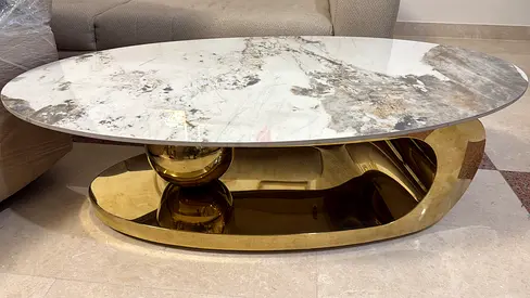 Modern oval marble-top coffee table with gold base