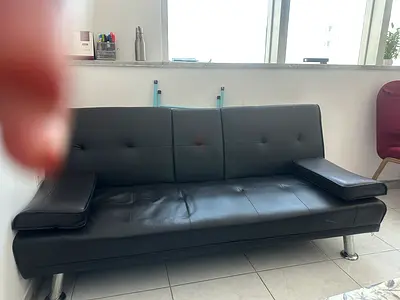 Black faux leather 3-seater sofa bed with chrome legs