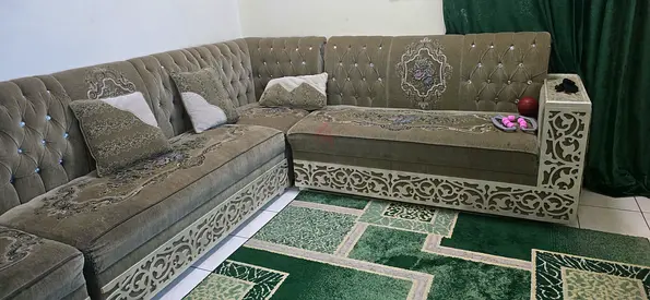 Large L-shaped upholstered corner sofa set with decorative wooden trim