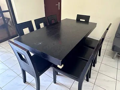 Solid black wooden dining table with 8 chairs (Urgent moving out sale)
