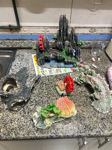 Assorted aquarium decorations — caves, castle, plants, wheel (used)