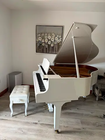 A beautiful glossy white K. Kawai grand piano