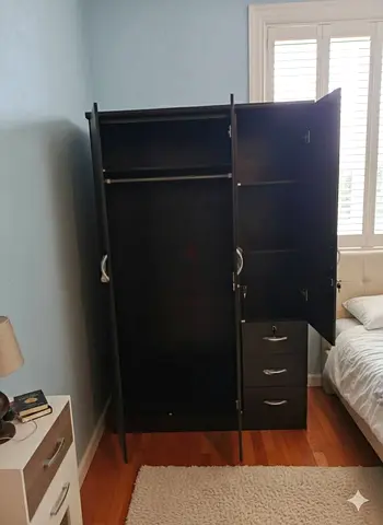 Dark brown freestanding wardrobe with drawers and hanging rail