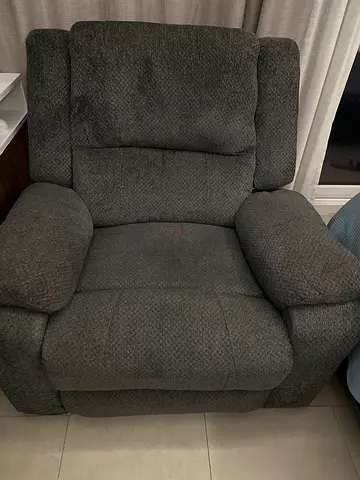 Single grey fabric recliner armchair in good condition