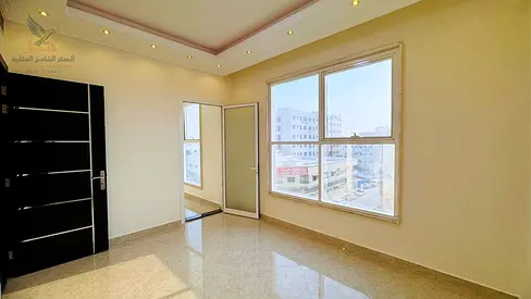 Two-bedroom apartment with a living room for annual rent in Ajman, Al Rawda 3 area, featuring very high-end finishing and a prime location.