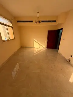 Unfurnished, self-contained one-bedroom apartment with a living room and a side sea view; all bills