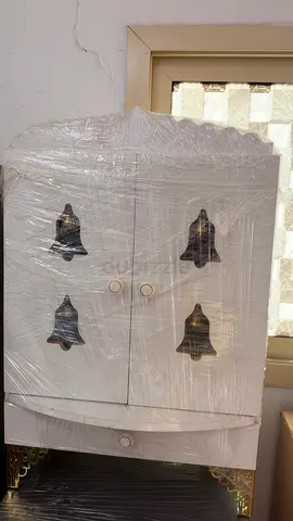 White Wooden Cabinet with Decorative Bell Cutouts - Good Condition